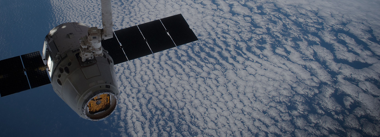 Dragon in space with solar panels extended